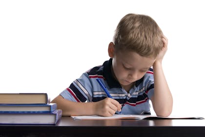 Child with dyslexia struggling to write
