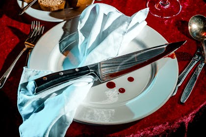Bloody knife on a plate