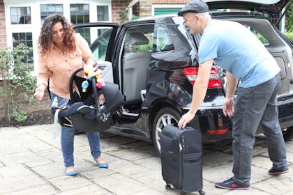 Family loading car for holiday