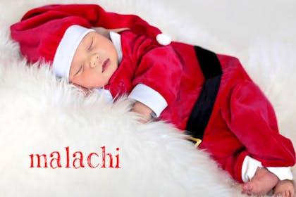 Sleeping baby in santa suit