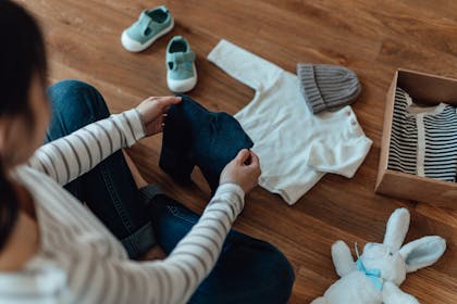 mum with baby clothes