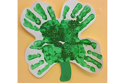 Four leaf clover shamrock made from green handprint paint