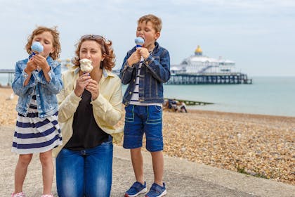 Family eating ice cream at Eastbourne beach