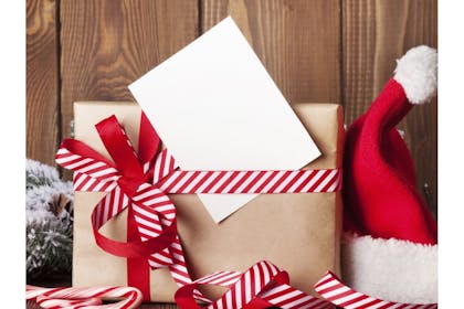 gift wrapped in brown paper and red and white ribbon