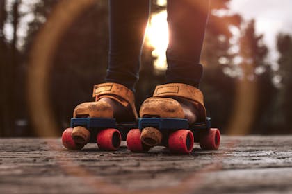 child's feet wearing 1980s roller skates