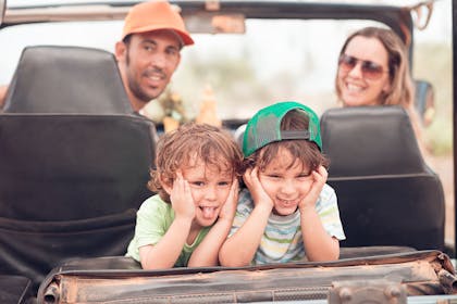 Kids laughing in the backseat of a car