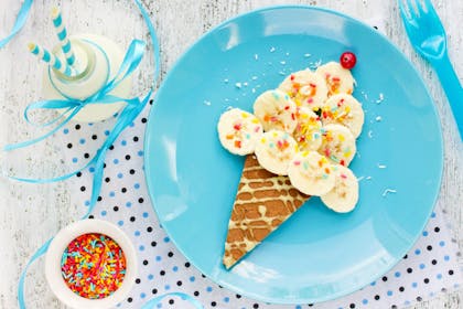 Ice cream pancake cone with sliced banana and sprinkles