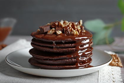 Chocolate pancakes with sauce and toppings