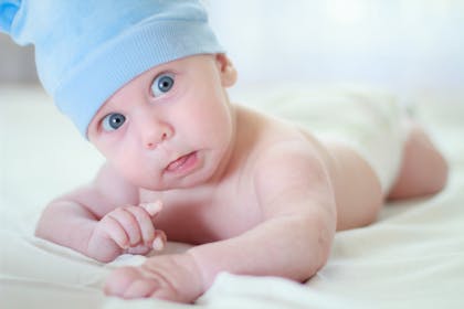 Baby in blue hat looking surprised