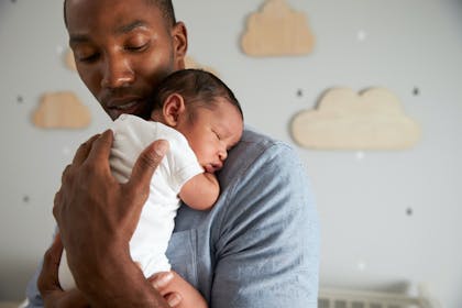 Man holding newborn baby