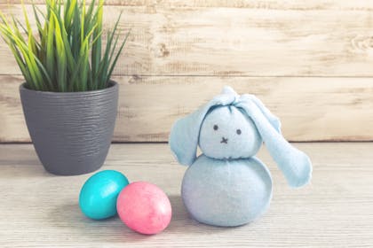 Sock bunny toy next to Easter eggs