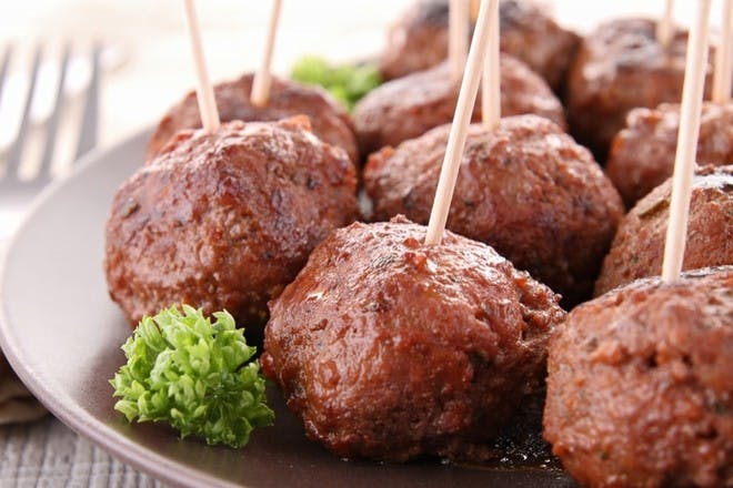 Plate of meatballs with cocktail sticks in them