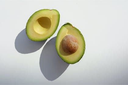 Avocado sliced in half on white background