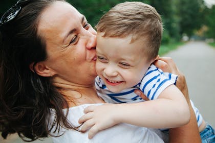 Mum kisses little boy on cheek