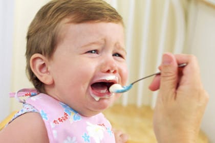 baby crying while being fed