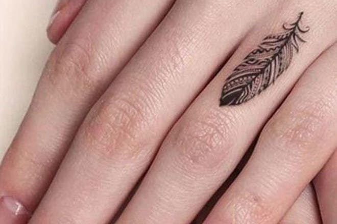 Finger feather tattoo