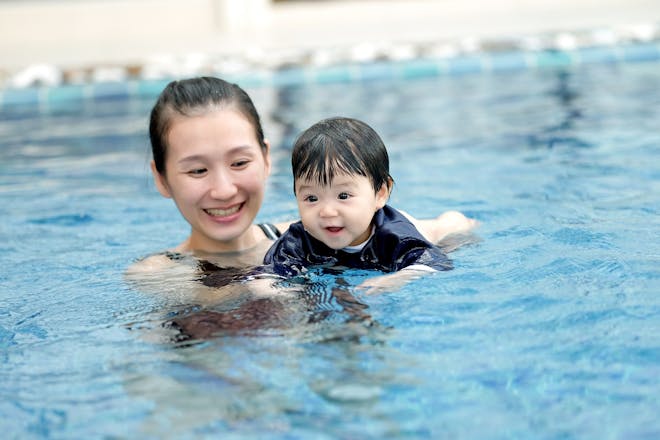 Mum and baby swimming in pool