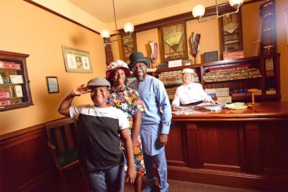 A family enjoy trying on hats at York Castle Museum