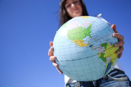 Teenager holding globe