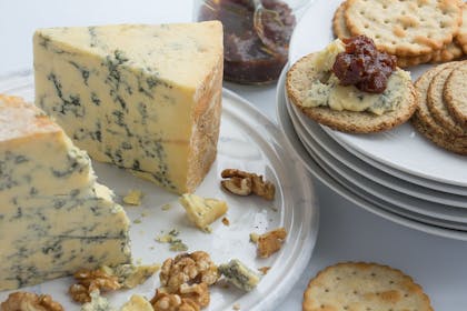 Stilton, crackers and walnuts on plates
