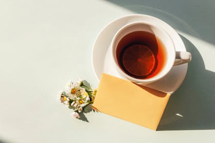 Cup of tea and card in envelope