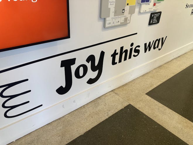 A sign at the Young V&A reads, 'Joy this way'. Image: author's own