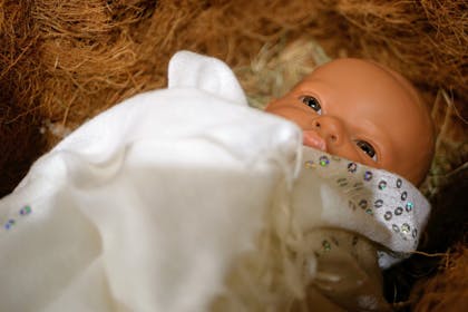 Doll in a manger for a church crib service at Christmas 
