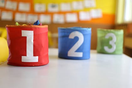 colourful storage pots with numbers on them in classroom