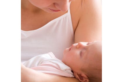 woman holding sleeping baby