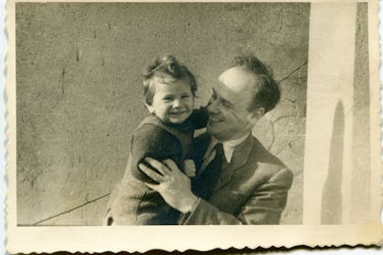 Black and white vintage family photo of dad holding toddler daughter