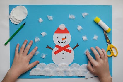Child's painting of snowman with cotton wool as snow