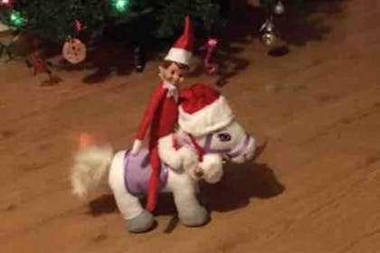 Christmas Elf on the Shelf rides a toy pony