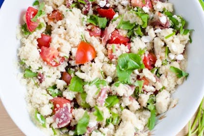 Bowl of couscous, tomato and feta salas with parsley