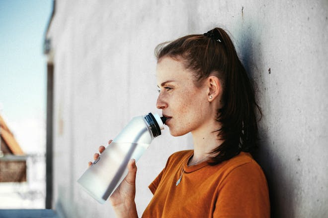 Woman drinking air up bottle