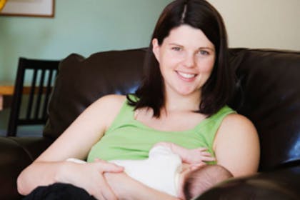 A woman breastfeeding her baby