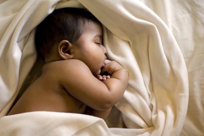 Baby sleeping in sheets