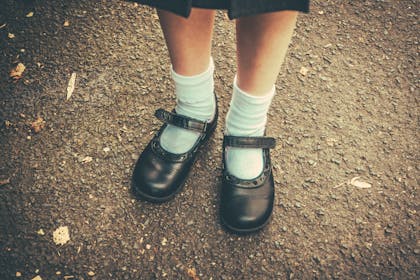 Girl in school shoes and uniform