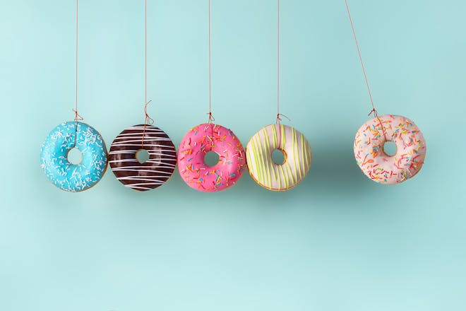 Five colourful doughnuts hanging on string