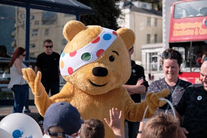 Pudsey bear in a crowd of kids