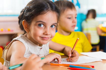 group of young children drawing in classroom 