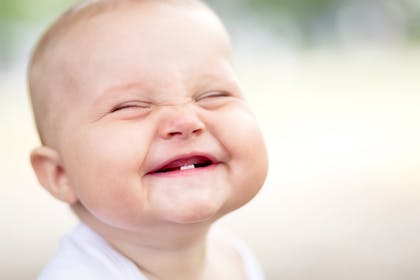 Baby grinning and showing teeth