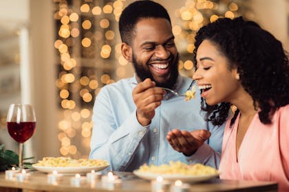 Couple eating pasta together 