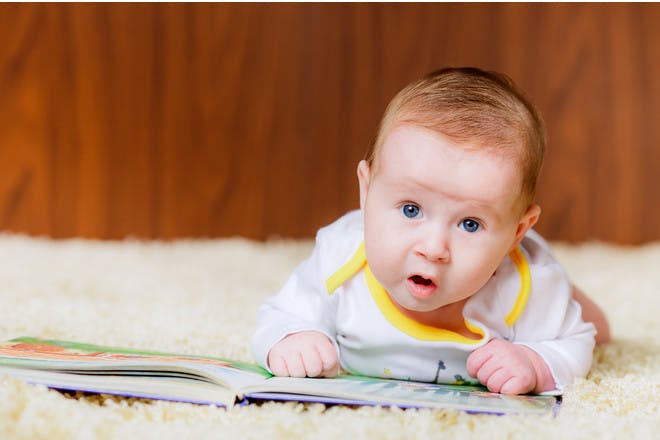 baby on stomach with book