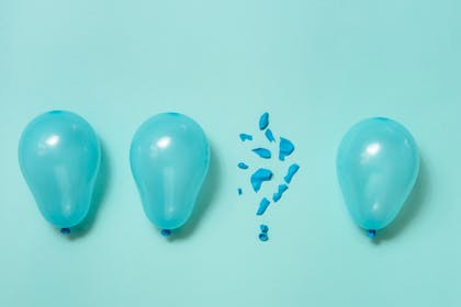 Blue balloons with one popped