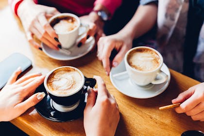 Group of hands holding coffees
