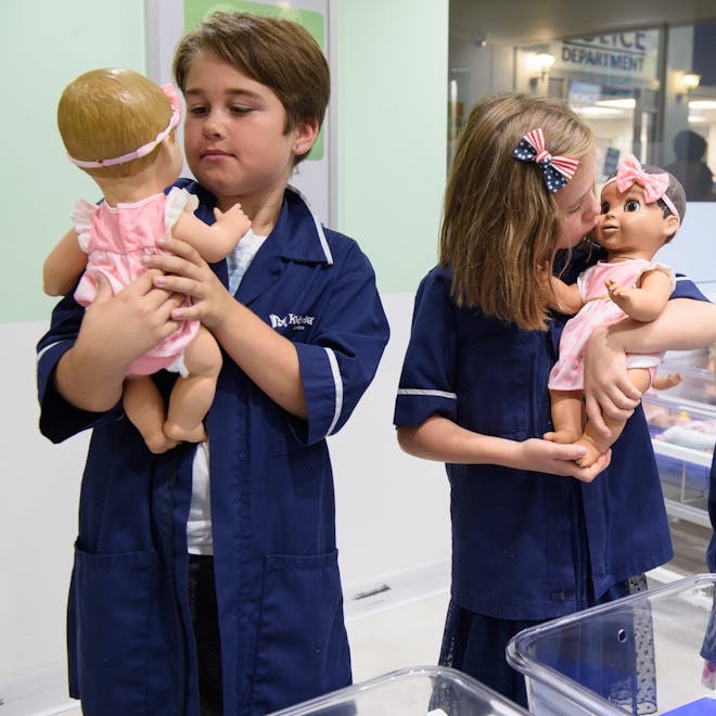 Two kids role play staff in the maternity unit at the KidZania hospital