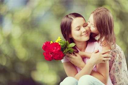 Mum and daughter holding flowers