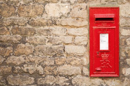 Red post box in wall