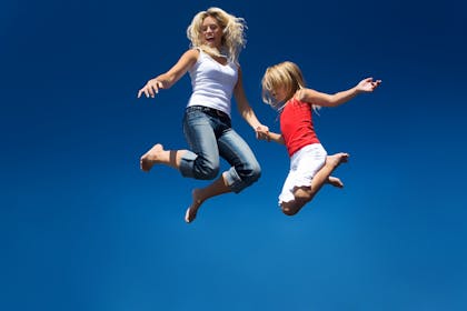 Woman and child jumping