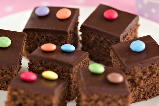 PLate of chocolate cakes with smarties on top
